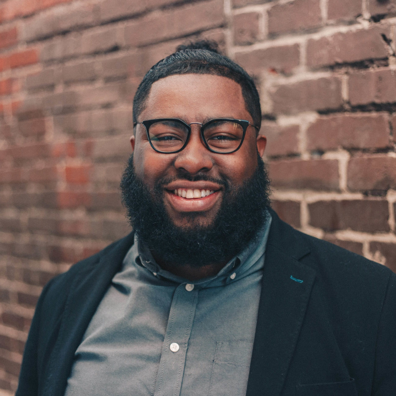 Stanley, a smiling man with a beard and glasses.